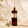 Huile Précieuse Spray Solaire Terre Des Huiles — flacon ambré pompe dorée, fond zellige marocain