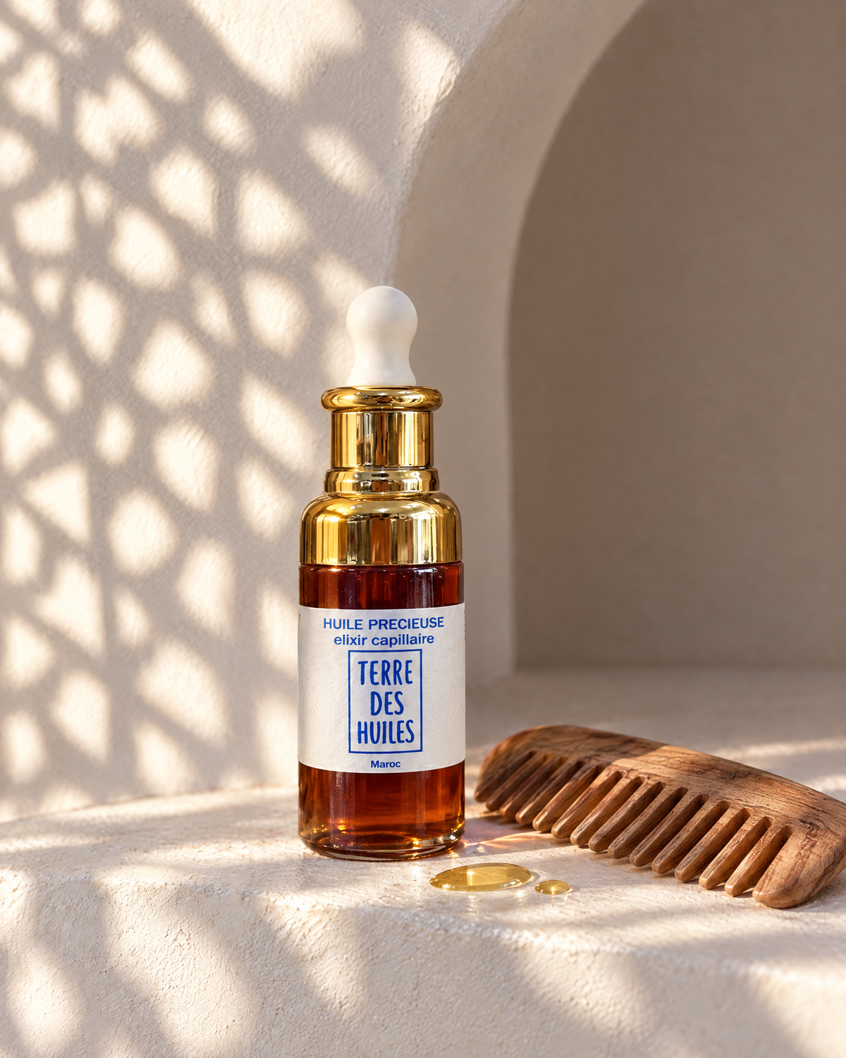 Élixir capillaire Terre Des Huiles avec peigne en bois, lumière marocaine