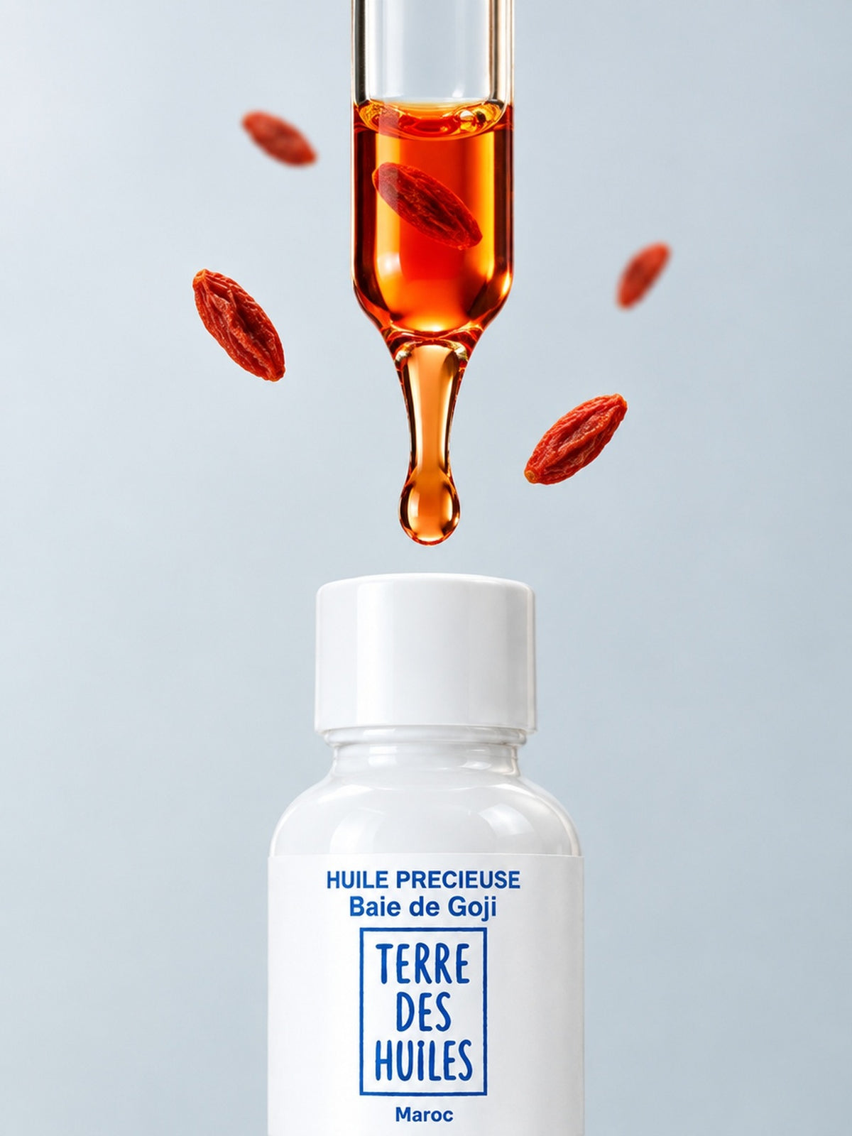 Pipette d'huile précieuse de goji Terre Des Huiles, huile rouge macérée avec de la carotte, au-dessus du flacon blanc